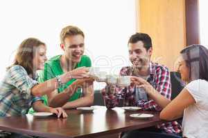 Four casual students drinking a cup of coffee