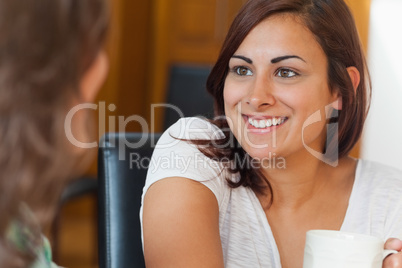 Two happy students having a cup of coffee