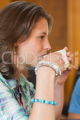 Pretty student drinking a cup of coffee