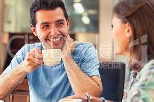Two laughing students having a cup of coffee
