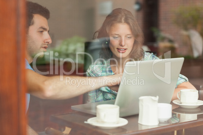 Two students looking at laptop