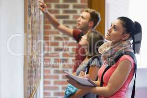 Students looking at notice board