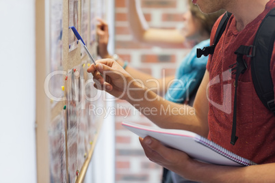 Casual students searching something on notice board