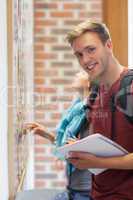 Cheerful student searching something on notice board