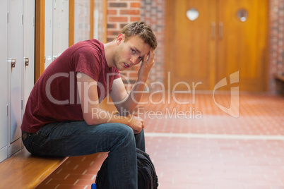 Frowning handsome student having a headache