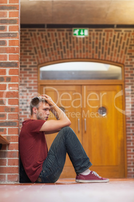 Unhappy handsome student having a headache