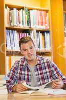 Handsome happy student studying his books