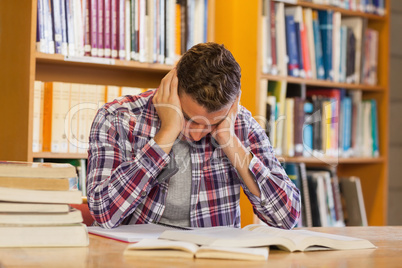 Handsome frustrated student studying his books