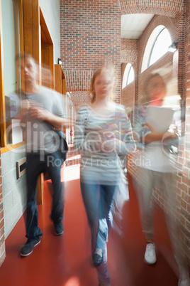 Students walking through hallway toward camera
