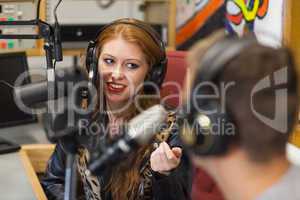 Attractive happy radio host interviewing a guest