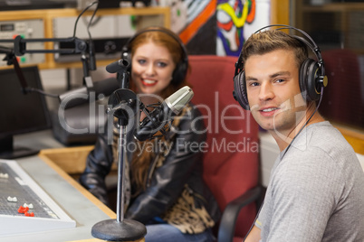 Attractive cheerful radio host interviewing a guest