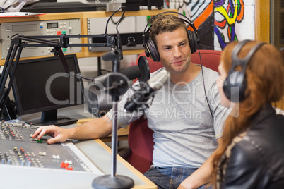 Attractive content radio host interviewing a guest