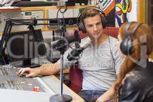 Attractive content radio host interviewing a guest