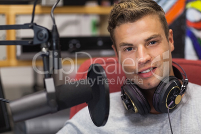 Handsome smiling singer recording a song