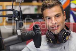 Handsome smiling singer recording a song