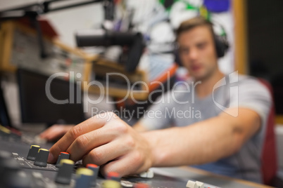 Handsome radio host moderating touching switch