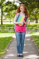 Gorgeous smiling student carrying notebooks