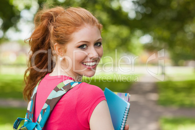 Gorgeous cheerful student holding notebooks