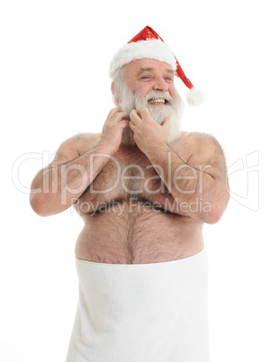 a half naked santa claus is taking care for his beard