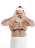 a half naked santa claus is taking care for his beard