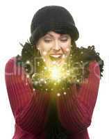 excited woman in winter clothes holds something sparkling in han