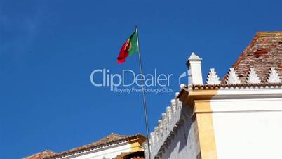 Waving Portugal flag on a blue sky