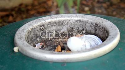 Smoke on ashtray with several cigarette butts not healthy death