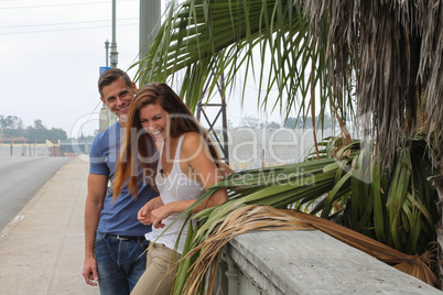 young couple palm tree