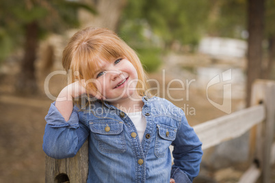 cute young girl posing for a portrait outside