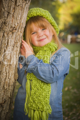 portrait of cute young girl wearing green scarf and hat