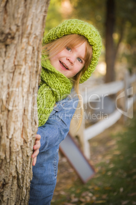 portrait of cute young girl wearing green scarf and hat