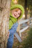 portrait of cute young girl wearing green scarf and hat