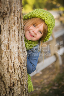 portrait of cute young girl wearing green scarf and hat