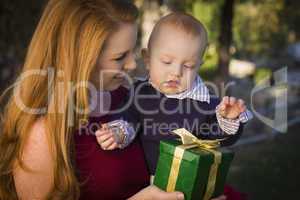 beautiful young mother and baby with christmas gift