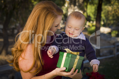 beautiful young mother and baby with christmas gift