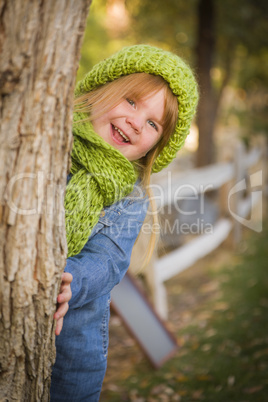 portrait of cute young girl wearing green scarf and hat