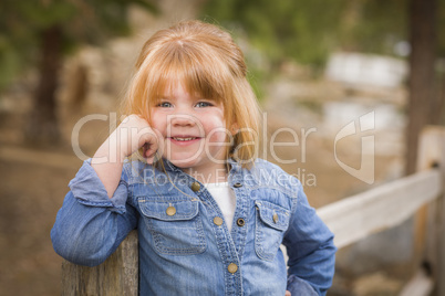 cute young girl posing for a portrait outside