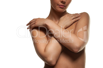 topless woman with her arms across her breasts