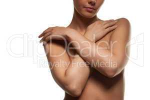 topless woman with her arms across her breasts