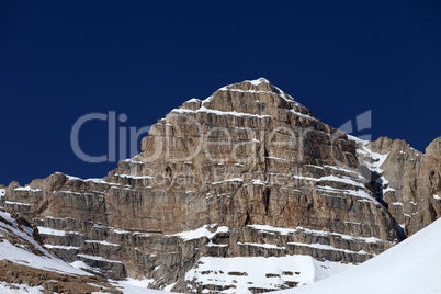 rocks in snow and blue clear sky