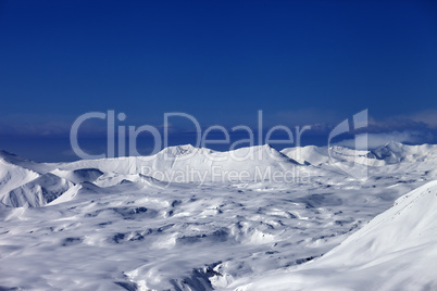 snowy plateau and off-piste slope at sun day