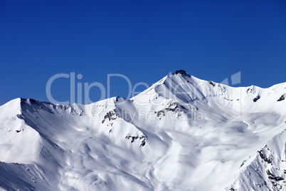 off-piste snowy slope and blue clear sky