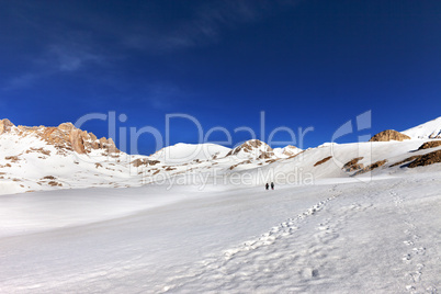 two hikers on snow plateau