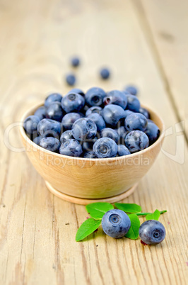 blueberries in a wooden bowl on the board