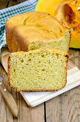 bread pumpkin on a board with a pumpkin