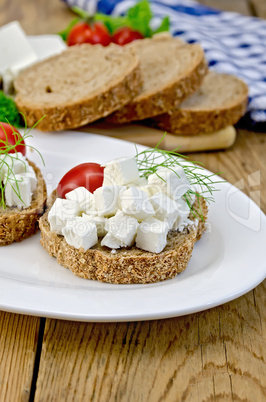 bread with feta cheese and tomatoes on the board