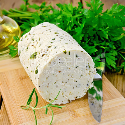cheese homemade with herbs and knife on board