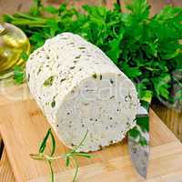 cheese homemade with herbs and knife on board