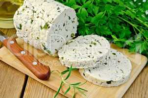 cheese homemade with herbs cut on a board