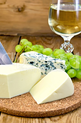 cheese with wine and grapes on the board